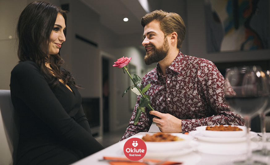 Couple dining, man offering rose